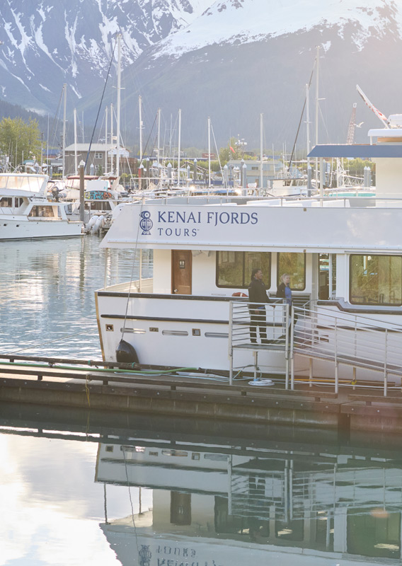 A group of people on the dock boarding a KFT boat