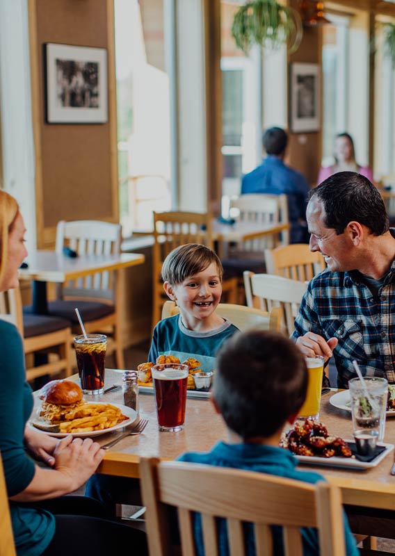 A family sits together for a meal in a restaurant.