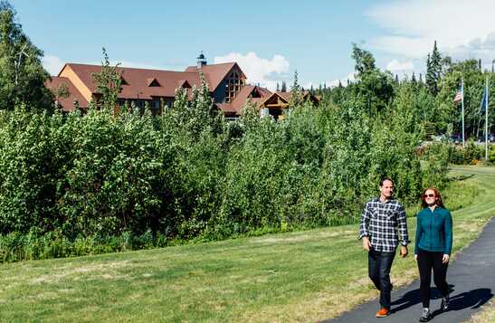 Two people walking outside of Talkeetna Alaskan Lodge