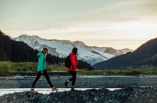 Two people hiking near the mountains