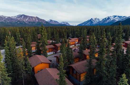 An aerial view of Denali Cabins with the mountains in the background