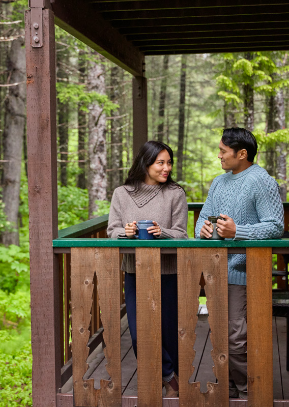 A couple drinking coffee on their balcony