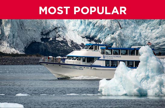 A boat moves past a large glacier