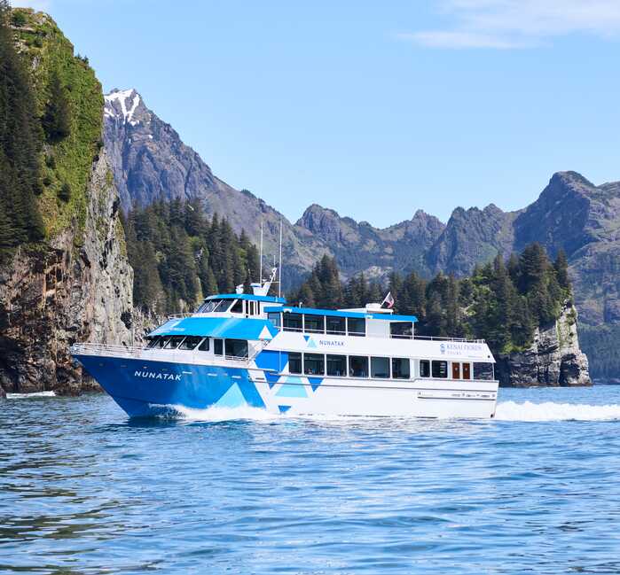 A Kenai Fjords Tours boat sailing through Ressurection Bay in Alaska.