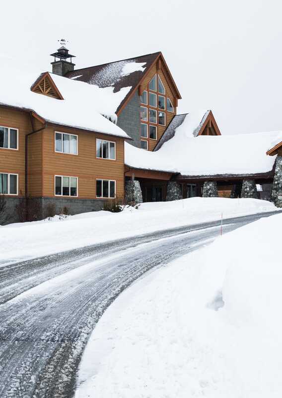 The driveway to the Talkeetna Alaskan Lodge entry, with snow on either side.